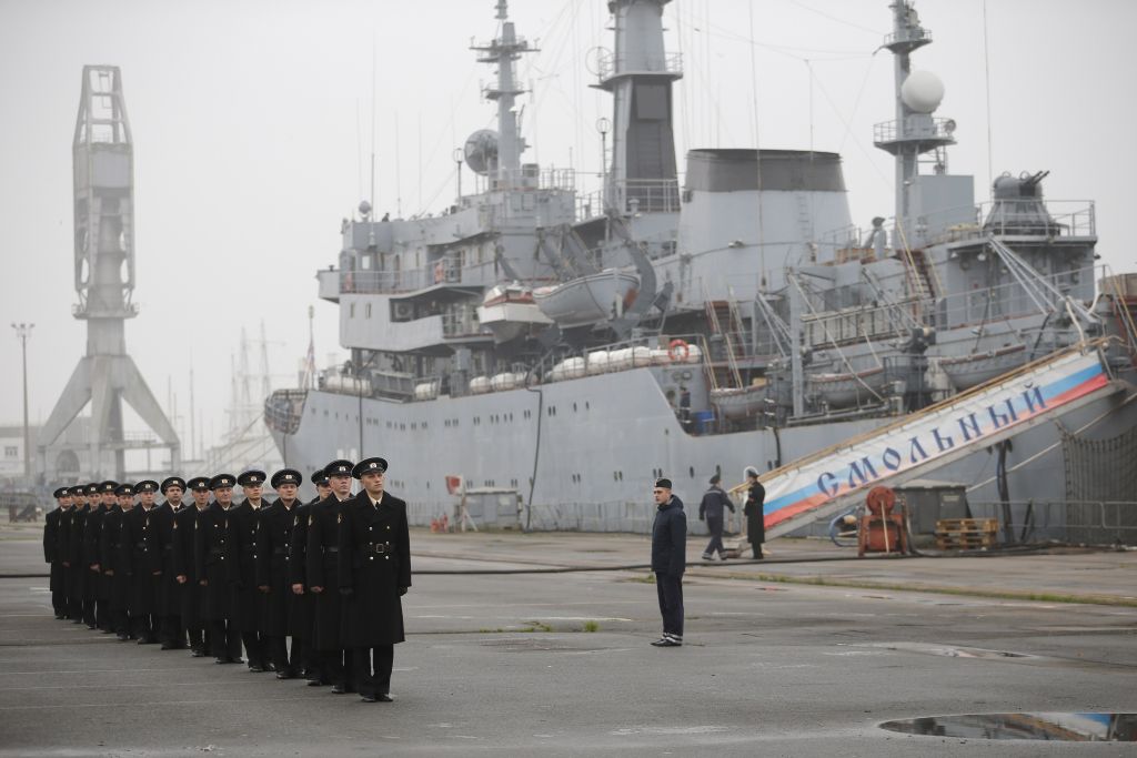 Russian sailors stand in formation in front of their Russian navy frigate Smolny at the STX Les Chantiers de l'Atlantique shipyard site in Saint-Nazaire, western France